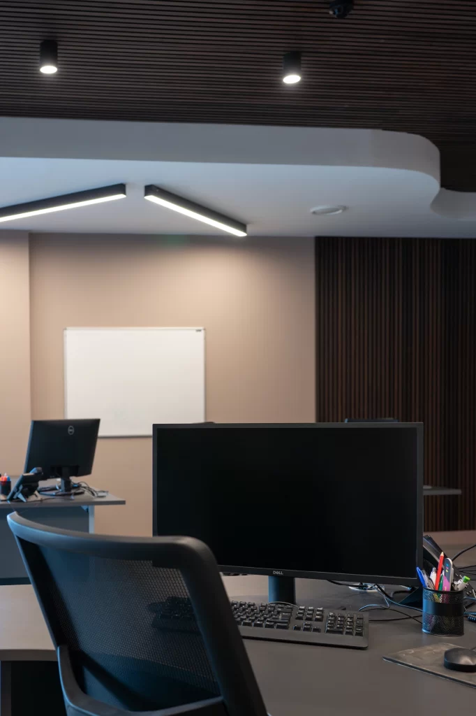 Office workspace at Enterprise House Malton with mesh chair, Dell monitor, whiteboard, and wood-panelled walls in a clean, modern setting